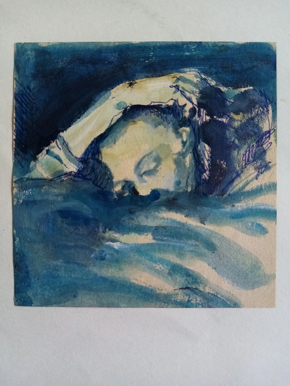 A head resting on an arm, painted in blue wash