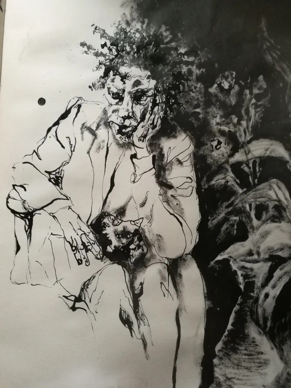 An ink drawing of a wild-haired figure with a raised arm among crowded faces