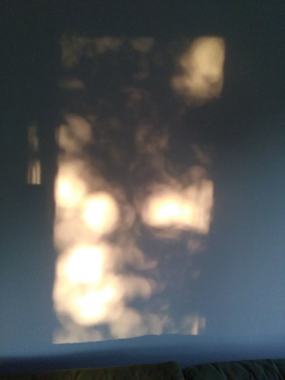 Daylight spilling across a wall in a soft, blurred rectangle